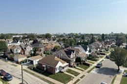 Aerial view of a sunny neigborhood with single-family homes