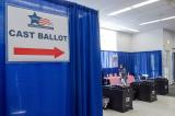 photo of voters casting their ballots at a polling station