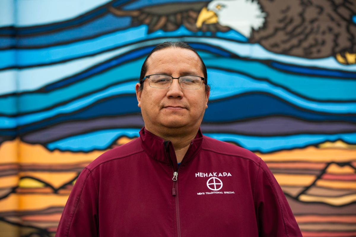 A teacher shows first-grade students how to pronounce vowels in the Lakota language.